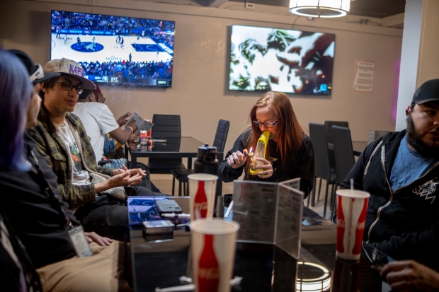 Calie Clark smokes cannabis from a ...