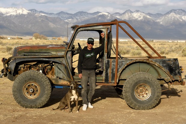 Mike Biggo, co-owner of Area 420, stands with his dog, Stash, in front of his business vehicle on April 20, 2022, in Moffat. (Photo by Helen H. Richardson/The Denver Post)