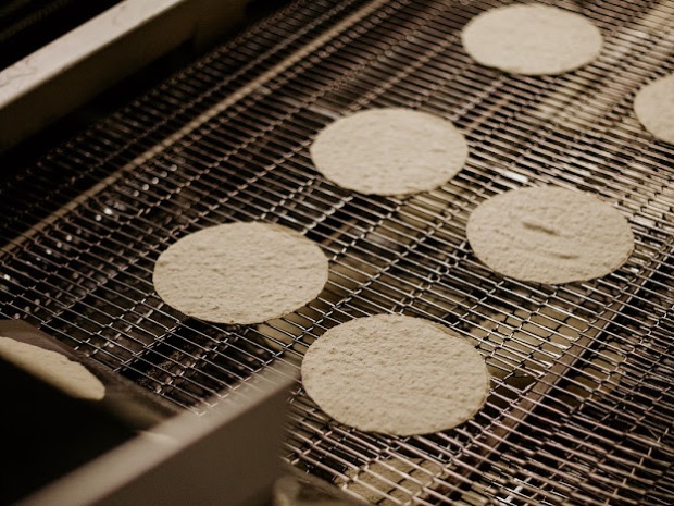 Tortillas on the conveyor belt at ...