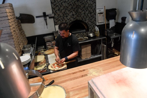 LAKEWOOD, CO - MAY 17: Kitchen manager Manny Andrade makes a pizza at Abrusci's Fire and Vine on May 17, 2021. (Photo by AAron Ontiveroz/The Denver Post)