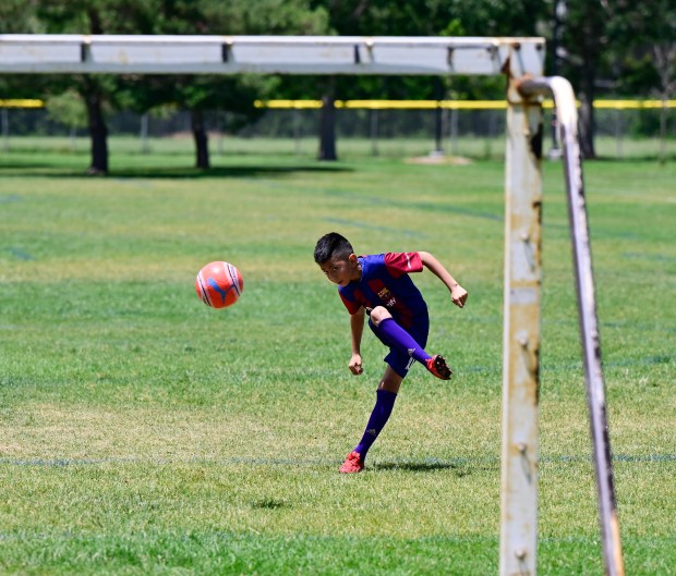Abel Maldonado-Ramirez, 9, practices his soccer skills at Montbello Central Park in Denver on Friday, June 21, 2024. (Photo by Andy Cross/The Denver Post)